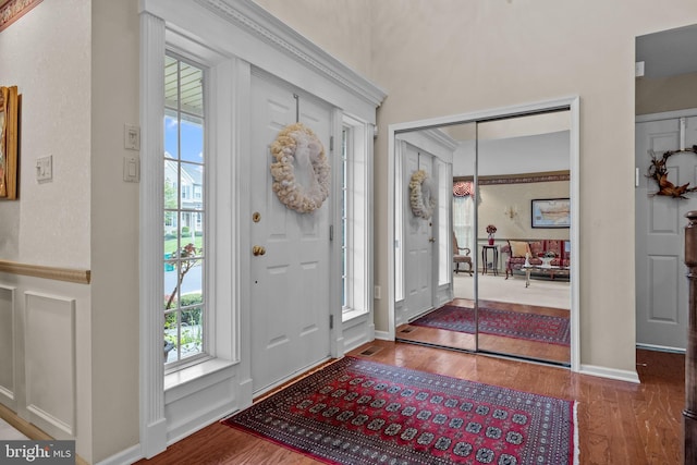 entrance foyer featuring wood finished floors and a healthy amount of sunlight