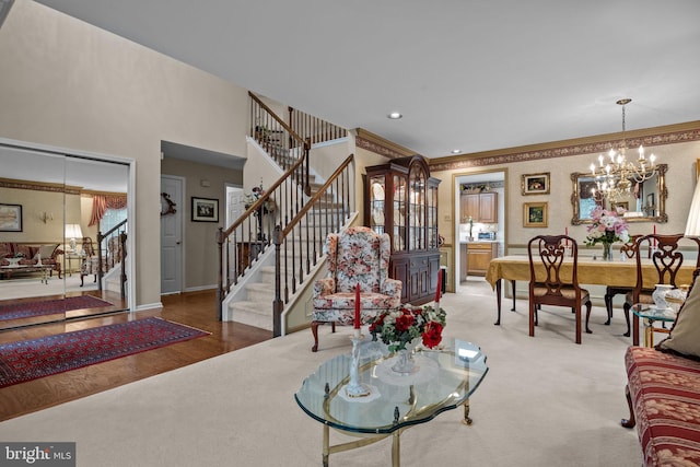 living room featuring baseboards, stairs, a notable chandelier, and recessed lighting