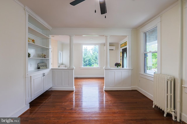 3614 Keene Ave, Baltimore, MD 21214 - unfurnished dining area featuring radiator, ornate columns, dark wood finished floors, healthy amount of natural light, and crown molding