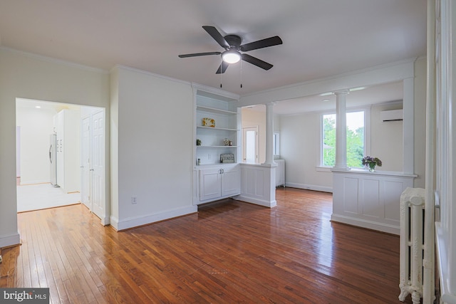 3614 Keene Ave, Baltimore, MD 21214 - spare room with decorative columns, a wall unit AC, radiator, ornamental molding, and dark wood-type flooring
