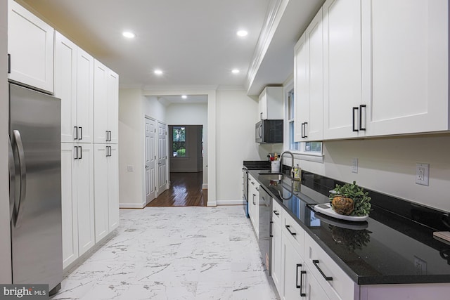 3614 Keene Ave, Baltimore, MD 21214 - kitchen with appliances with stainless steel finishes, ornamental molding, white cabinets, recessed lighting, and dark stone countertops