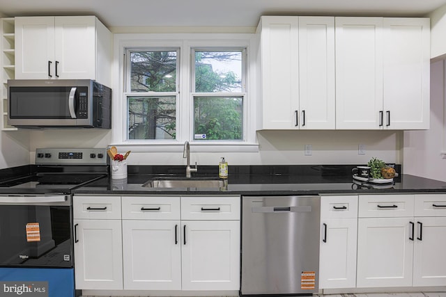 3614 Keene Ave, Baltimore, MD 21214 - kitchen with stainless steel appliances, a sink, white cabinets, open shelves, and dark stone counters