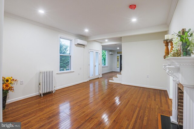 3614 Keene Ave, Baltimore, MD 21214 - unfurnished living room featuring radiator, a wall mounted AC, hardwood / wood-style floors, crown molding, and a fireplace with flush hearth