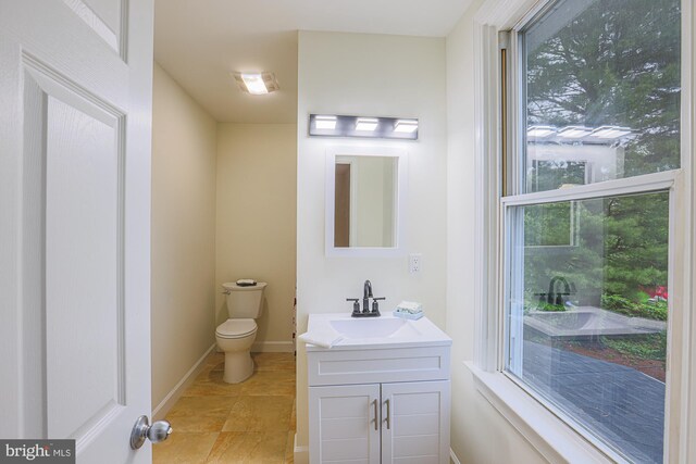 3614 Keene Ave, Baltimore, MD 21214 - half bathroom with toilet, vanity, plenty of natural light, and baseboards