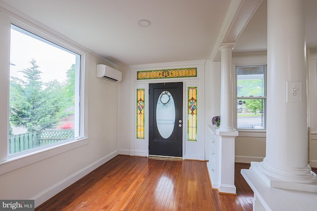 3614 Keene Ave, Baltimore, MD 21214 - foyer entrance with decorative columns, an AC wall unit, hardwood / wood-style flooring, ornamental molding, and baseboards