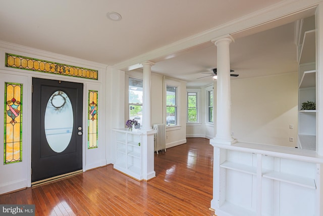 3614 Keene Ave, Baltimore, MD 21214 - entrance foyer featuring ornate columns, radiator heating unit, hardwood / wood-style floors, ceiling fan, and ornamental molding