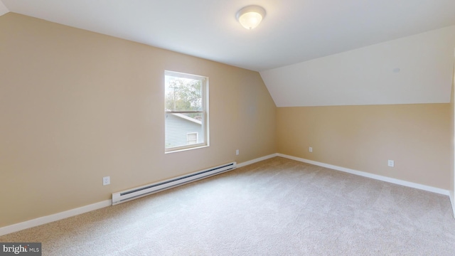 bonus room featuring a baseboard heating unit, lofted ceiling, light carpet, and baseboards