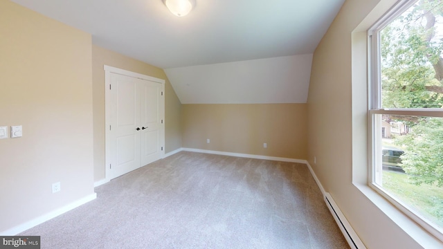 bonus room featuring carpet, plenty of natural light, vaulted ceiling, baseboards, and baseboard heating