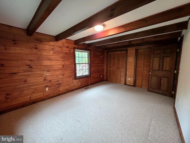 5925 Huntingtown Rd, Huntingtown, MD 20639 - unfurnished bedroom featuring carpet flooring, beamed ceiling, wood walls, and visible vents