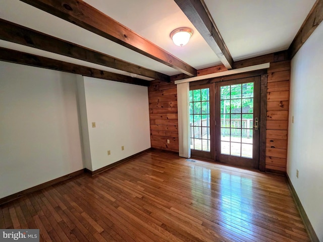 5925 Huntingtown Rd, Huntingtown, MD 20639 - unfurnished room with wood-type flooring, baseboards, wood walls, and beam ceiling