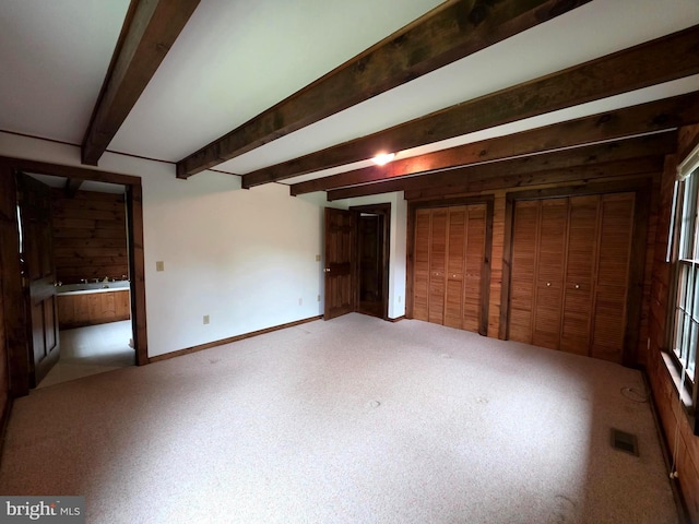 5925 Huntingtown Rd, Huntingtown, MD 20639 - unfurnished bedroom featuring beamed ceiling, carpet flooring, ensuite bath, and visible vents