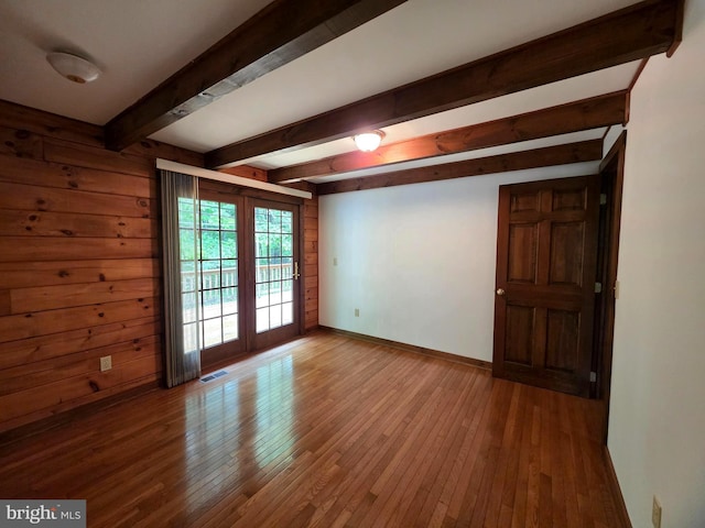 5925 Huntingtown Rd, Huntingtown, MD 20639 - unfurnished room with baseboards, beamed ceiling, hardwood / wood-style flooring, and visible vents