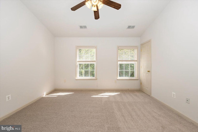 spare room featuring carpet, a ceiling fan, and baseboards