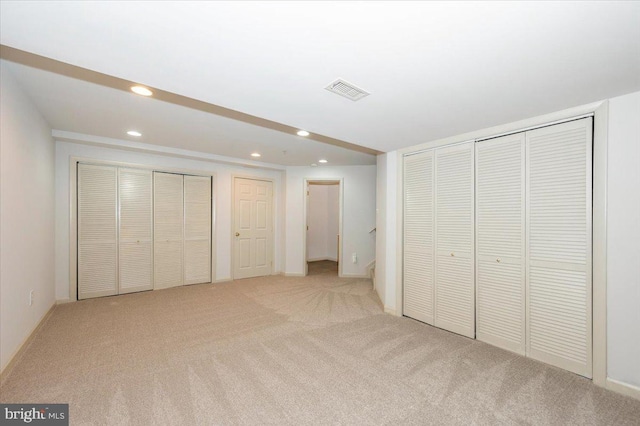 unfurnished bedroom with recessed lighting, light carpet, and baseboards