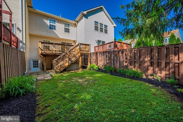 back of property featuring a deck and stairway