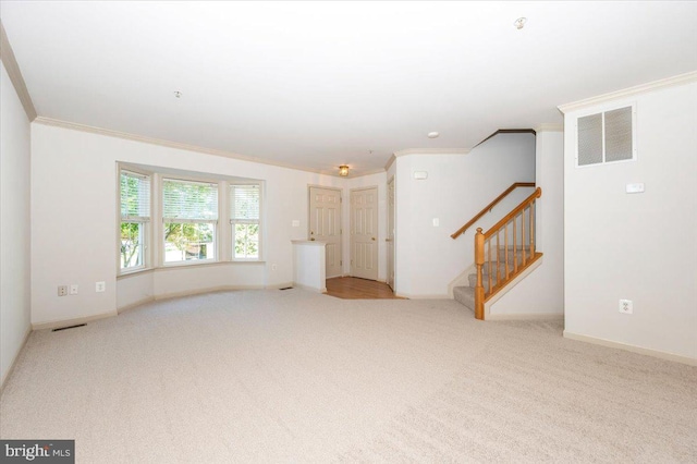 unfurnished living room featuring ornamental molding, carpet, stairway, and baseboards