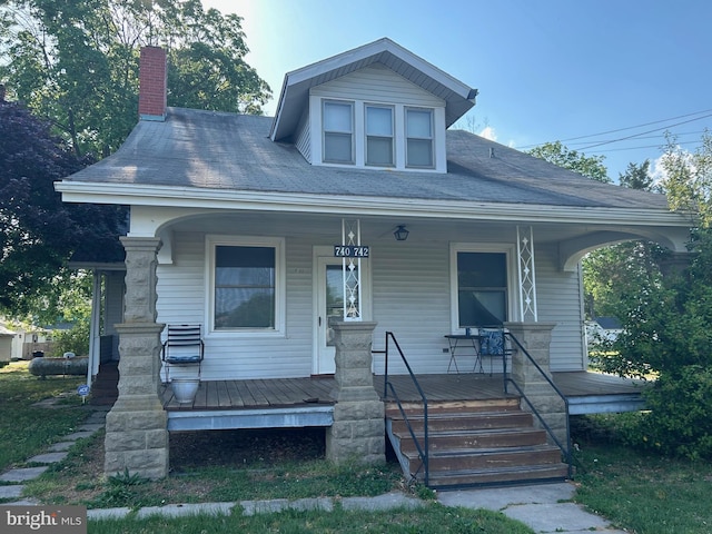 742 S State St, Dover, DE 19901 - bungalow-style home with a porch and a chimney