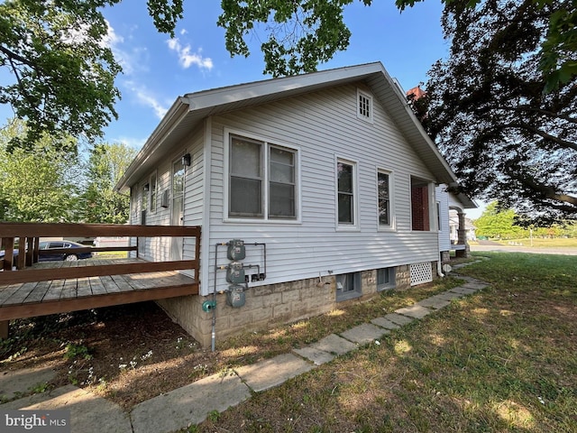 742 S State St, Dover, DE 19901 - view of home's exterior featuring a lawn and a wooden deck