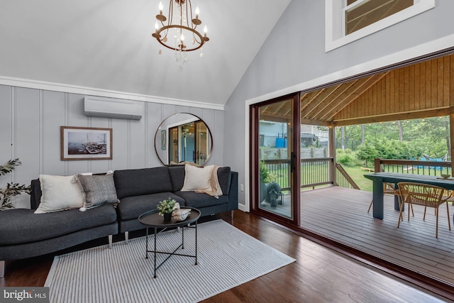 8014 Forest Glen Dr, Pasadena, MD 21122 - living area featuring a wall mounted AC, a decorative wall, wood finished floors, high vaulted ceiling, and a chandelier