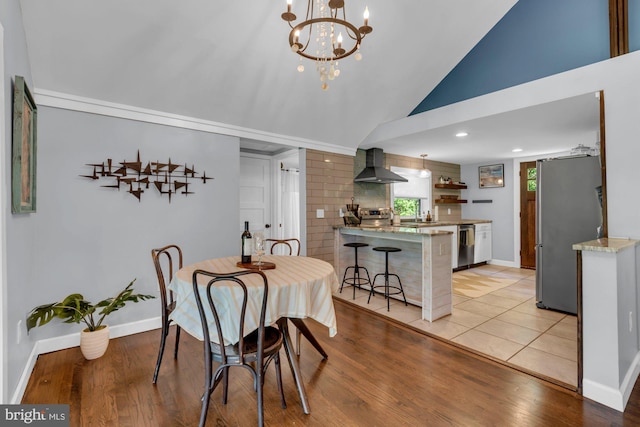 8014 Forest Glen Dr, Pasadena, MD 21122 - dining room featuring lofted ceiling, baseboards, a chandelier, light wood-style flooring, and recessed lighting