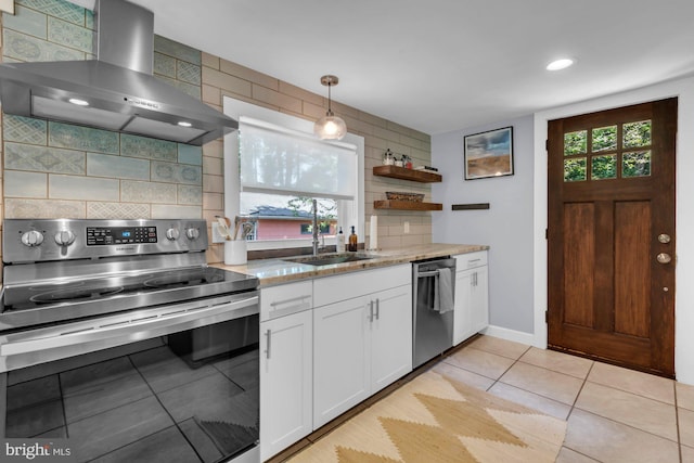 8014 Forest Glen Dr, Pasadena, MD 21122 - kitchen featuring appliances with stainless steel finishes, wall chimney exhaust hood, tasteful backsplash, white cabinetry, and recessed lighting