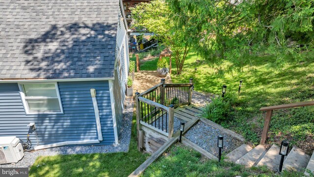 8014 Forest Glen Dr, Pasadena, MD 21122 - view of side of home featuring roof with shingles, a cooling unit, and a deck