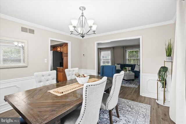 6122 Wallingford Way, Mechanicsburg, PA 17050 - dining space with an inviting chandelier, visible vents, wainscoting, and crown molding