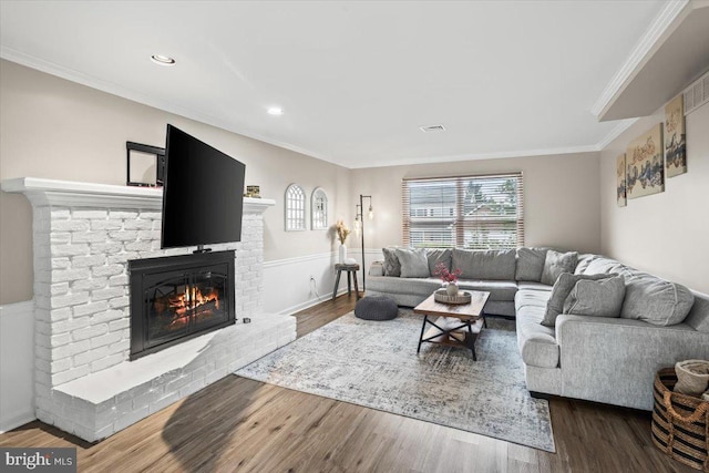 6122 Wallingford Way, Mechanicsburg, PA 17050 - living area with a brick fireplace, visible vents, crown molding, and wood finished floors