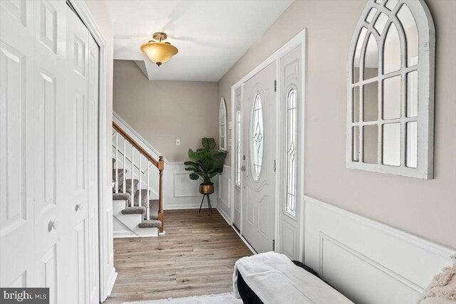 6122 Wallingford Way, Mechanicsburg, PA 17050 - entrance foyer featuring stairs, light wood-style floors, a decorative wall, and a wainscoted wall