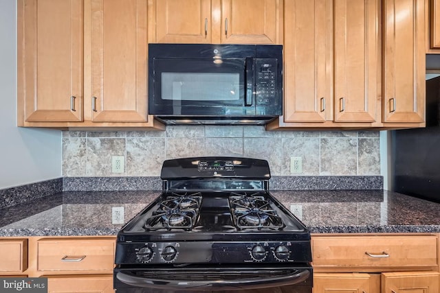 kitchen with backsplash, black appliances, and dark countertops