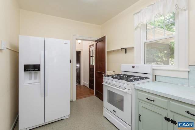 kitchen with white appliances, light floors, and light countertops