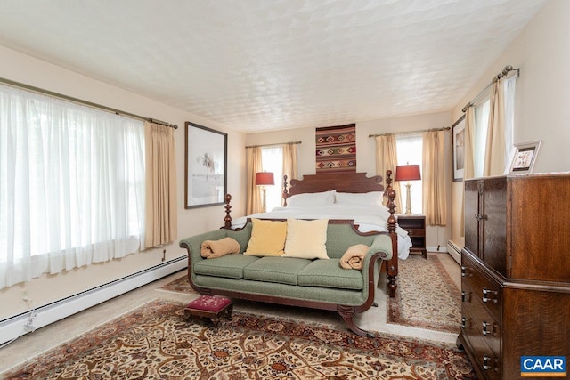 carpeted bedroom featuring a baseboard heating unit