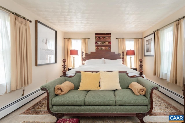 bedroom featuring multiple windows and baseboard heating