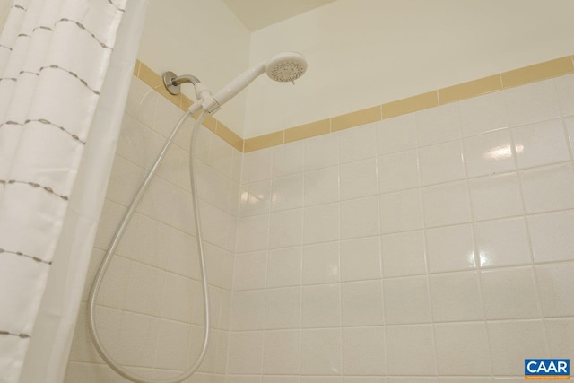 interior details featuring tiled shower