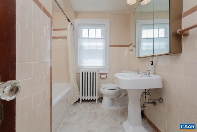 bathroom featuring toilet, tile walls, radiator heating unit, and shower / tub combo with curtain