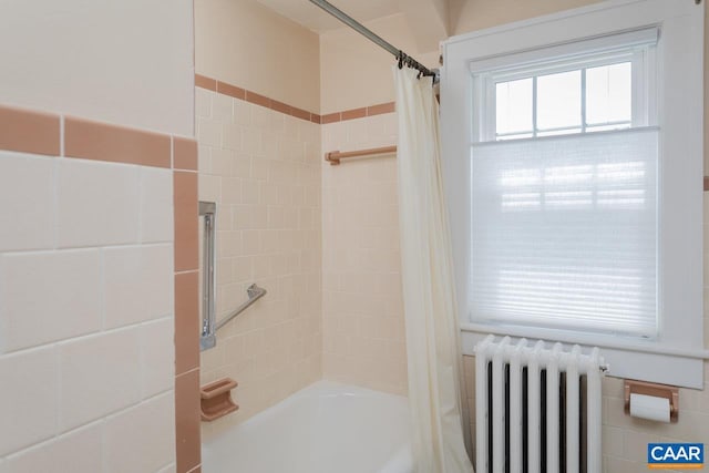 full bath featuring shower / bath combo with shower curtain and radiator heating unit
