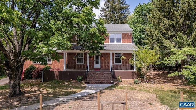 traditional home with brick siding and fence