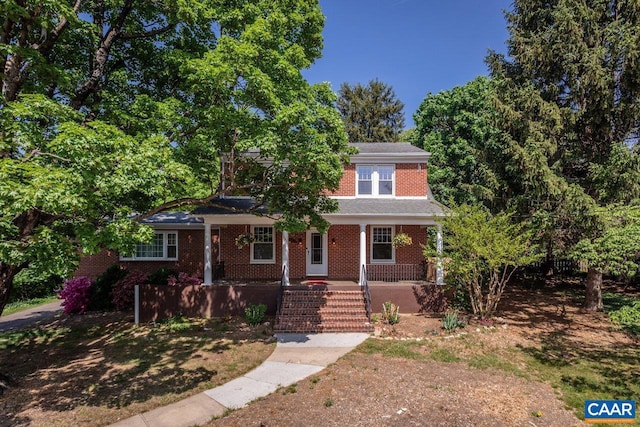 view of front facade with a porch and brick siding