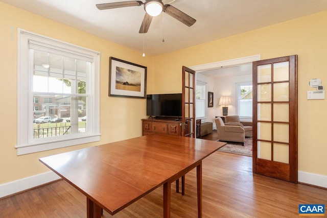 dining area featuring baseboards, plenty of natural light, and wood finished floors