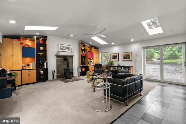 15708 Thompson Rd, Silver Spring, MD 20905 - living room featuring a skylight, a wood stove, healthy amount of natural light, recessed lighting, and vaulted ceiling