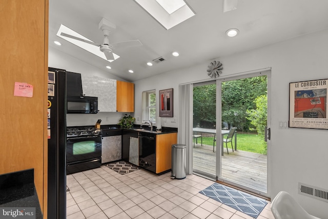 15708 Thompson Rd, Silver Spring, MD 20905 - kitchen with a skylight, black appliances, dark countertops, a sink, and plenty of natural light
