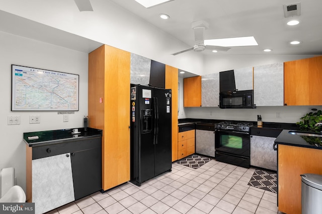 15708 Thompson Rd, Silver Spring, MD 20905 - kitchen with black appliances, a skylight, dark countertops, a ceiling fan, and light tile patterned flooring
