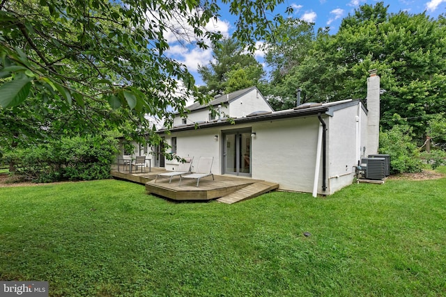 15708 Thompson Rd, Silver Spring, MD 20905 - back of property featuring stucco siding, central air condition unit, a lawn, a deck, and a chimney