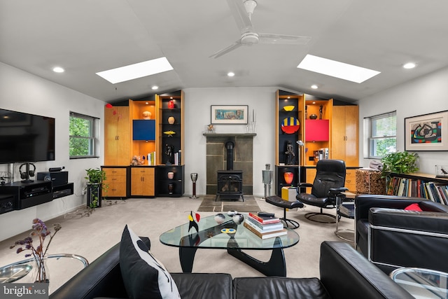 15708 Thompson Rd, Silver Spring, MD 20905 - living room with a skylight, vaulted ceiling, a wood stove, a ceiling fan, and recessed lighting