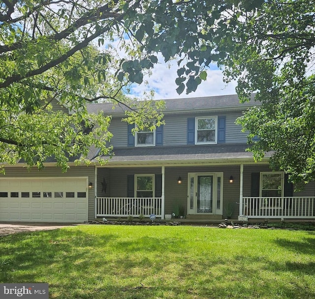 view of front of property featuring covered porch, a front yard, and an attached garage