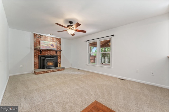 unfurnished living room featuring carpet flooring, baseboards, and ceiling fan