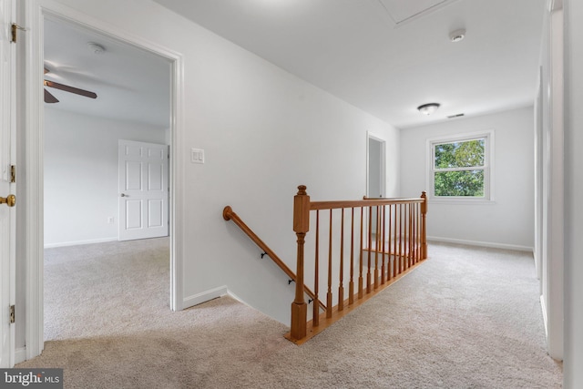 staircase featuring carpet, a ceiling fan, and baseboards