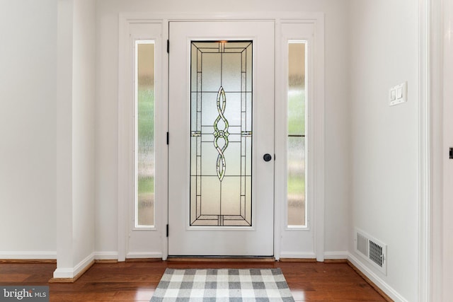 entrance foyer featuring wood finished floors and baseboards