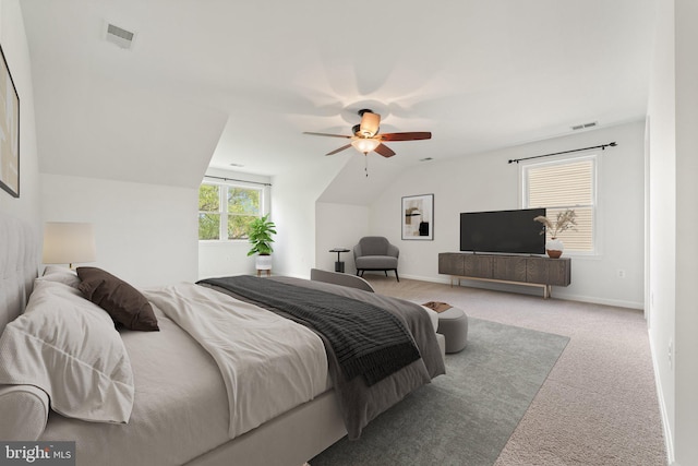carpeted bedroom with vaulted ceiling, ceiling fan, and baseboards