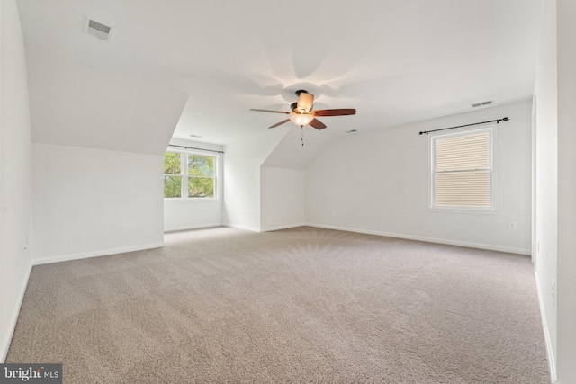 additional living space with a ceiling fan, lofted ceiling, carpet, and baseboards